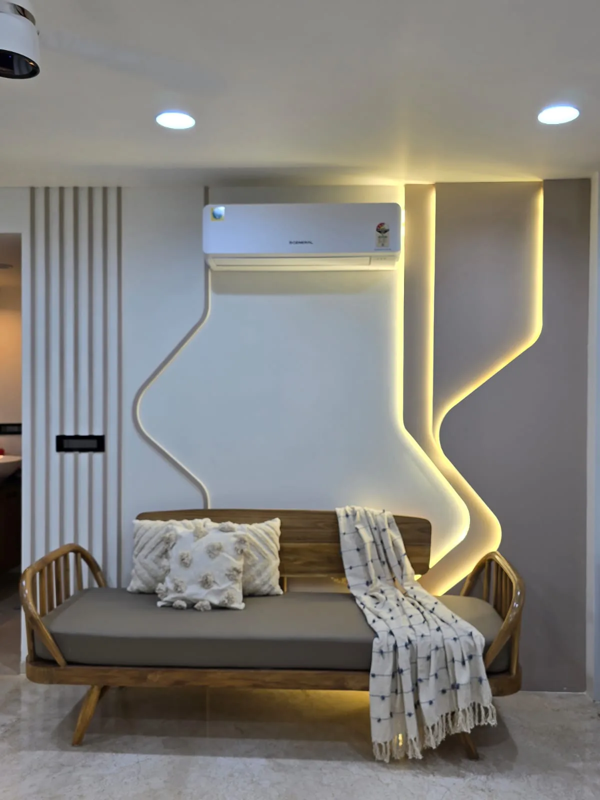 Lounge with cove lighting, a built-in daybed and coordinated ceiling and electrical detailing
