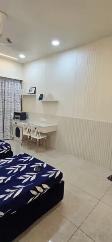 Children’s room with a fluted white wardrobe wall and a wall-hung twin study desk