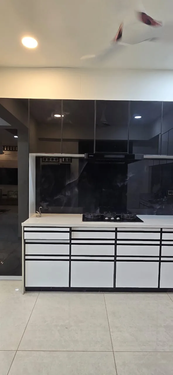 Kitchen hob run with a black glass backsplash, chimney and deep drawer banks below