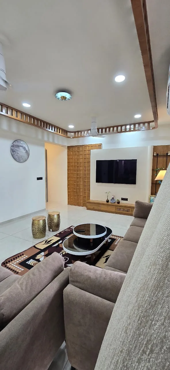 Living room seating with a sectional sofa, patterned rug and a tiered coffee table