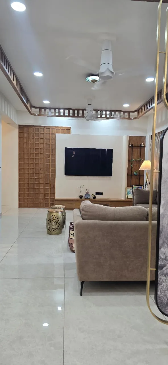 Living room TV wall with a veneered console and a full-height wooden grid screen alongside